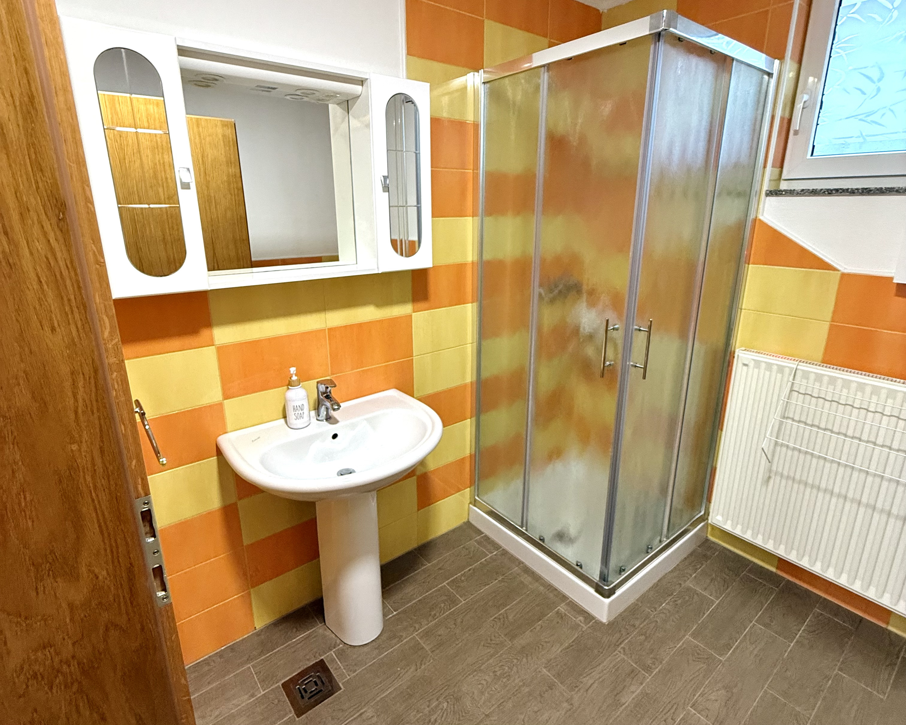 Bathroom with shower cabin and sink