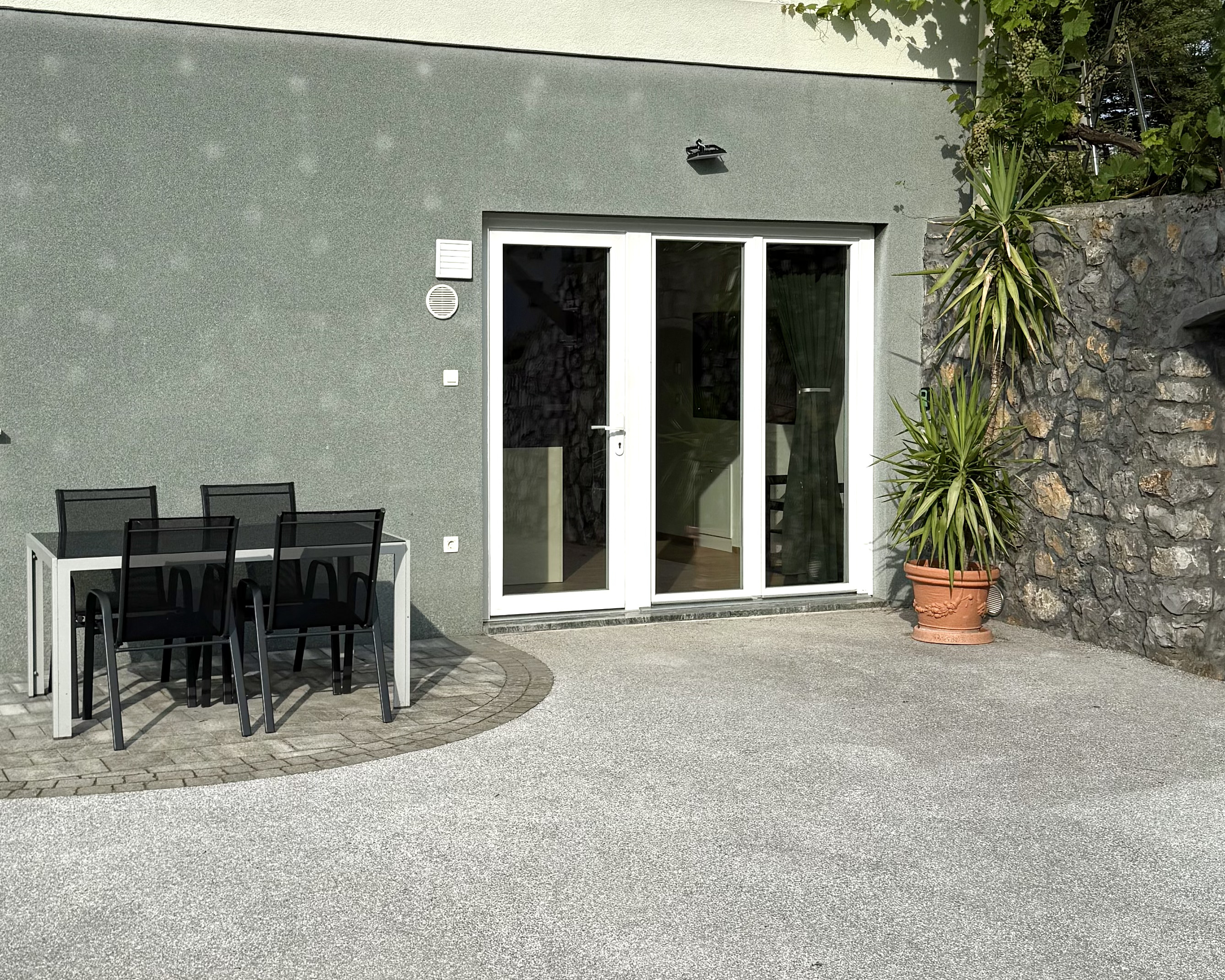 Exterior of Apartma Pija — terrace, outdoor dining and stone wall